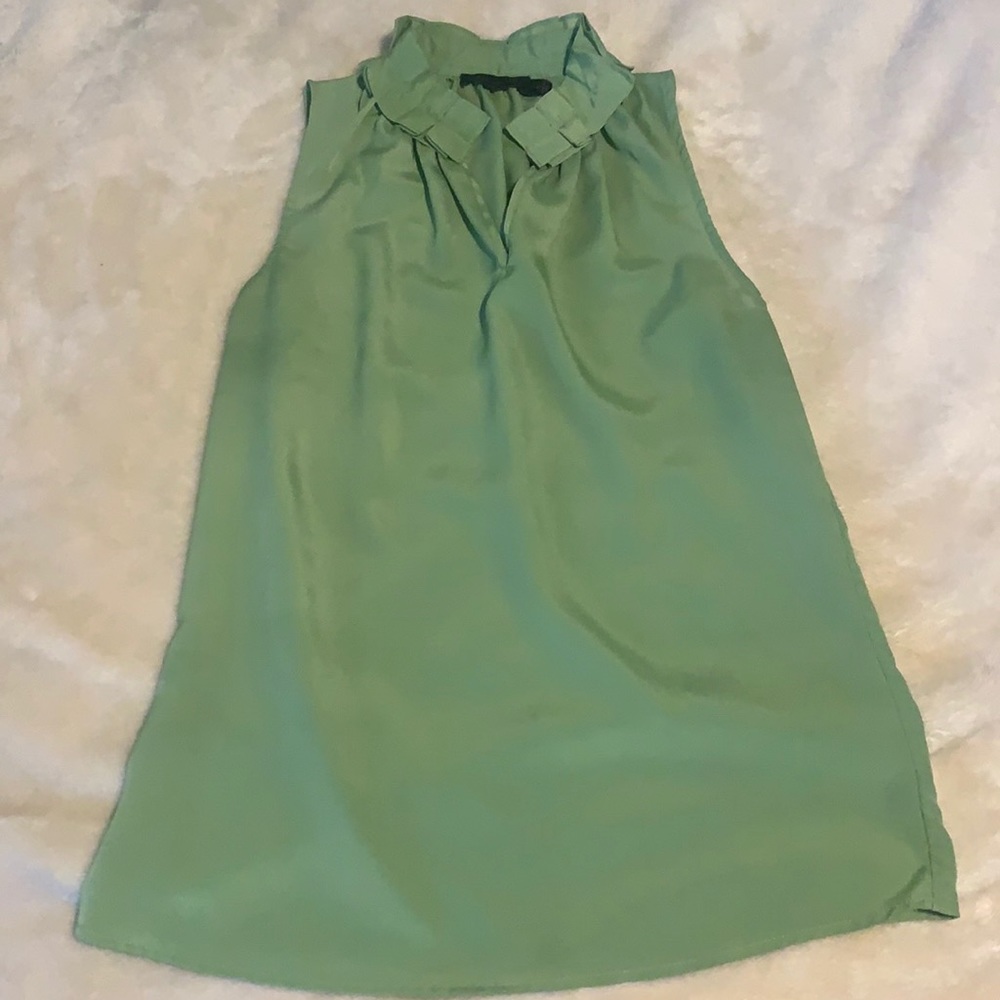 Green sleeveless top with ruffle neck